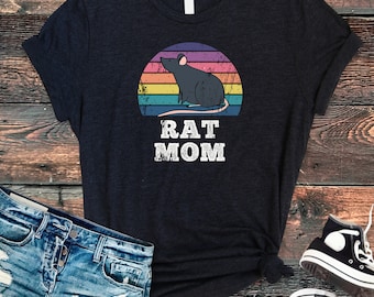 May include: A black t-shirt with a vintage-style rainbow graphic of a rat and the text "RAT MOM".