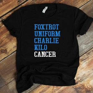 May include: Black t-shirt with the words "FOXTROT UNIFORM CHARLIE KILO CANCER" printed in blue and white.