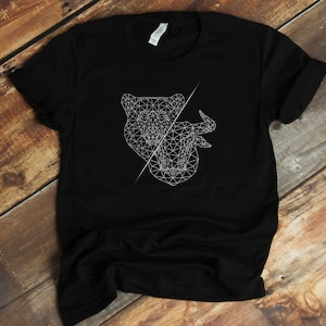 May include: Black t-shirt with a white geometric design of a bear and a bull's head.