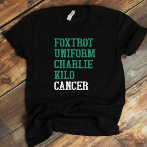 May include: Black t-shirt with a green graphic that reads "FOXTROT UNIFORM CHARLIE KILO CANCER".