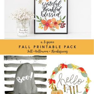 May include: A set of three printable fall-themed images. The first image features a watercolor wreath with the words "grateful thankful blessed". The second image features a ghost with the word "boo!" on a black and white striped background. The third image features a watercolor wreath with the words "hello fall" and a pumpkin.