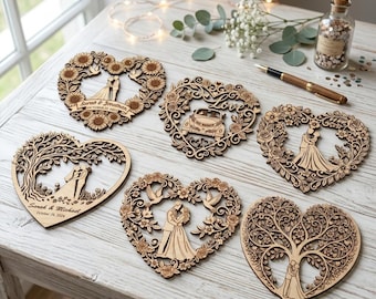 May include: Six heart-shaped wooden laser-cut ornaments featuring intricate floral, tree, and bird motifs. Two ornaments display engraved names and dates, including Sarah & Jonathan and Sarah & Michael. The designs depict couples in various poses.