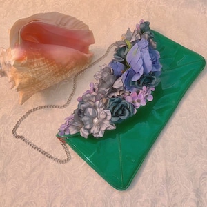 Campy silk flower covered patent bag