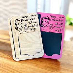 May include: Two memo boards, one natural wood and one pink, with the text "Things I need to remember but will probably forget." Each board features a retro illustration of a woman.