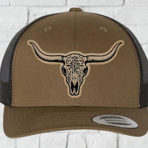 May include: A brown and black trucker hat with a decorative bull skull design. The hat has a mesh back and a curved brim. The text "INSTANT DIGITAL DOWNLOAD" is at the bottom of the image.