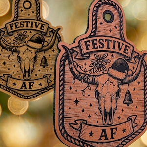 May include: Two brown wooden ornaments with a festive bull skull design. Each ornament features the word "FESTIVE" and "AF". One ornament has a Santa hat and a bell. The image also includes the text "INSTANT DIGITAL DOWNLOAD".