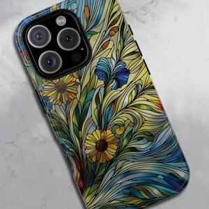 May include: A phone case with a stained glass design featuring blue, yellow, and green flowers and leaves.