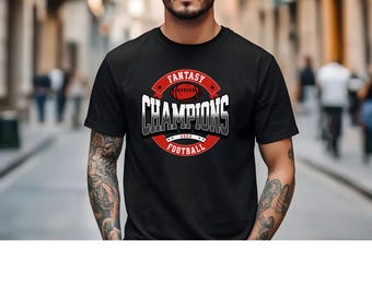May include: Black crew neck t-shirt with a circular graphic. The graphic features a football, the words "FANTASY CHAMPIONS" in a red and white design, and the word "FOOTBALL" below. The year "2024" is also included.