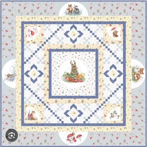 May include: A patchwork quilt with a light blue background and a central square featuring a rabbit surrounded by vegetables. The quilt has a floral pattern and circular illustrations of woodland creatures.