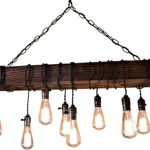May include: A rustic wooden chandelier with eight Edison bulbs hanging from black cords. The chandelier is suspended from a chain and has a dark brown finish.