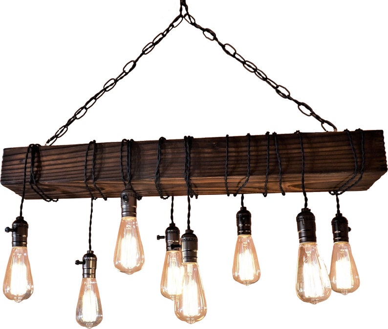 May include: A rustic wooden chandelier with eight Edison bulbs hanging from black cords. The chandelier is suspended from a chain and has a dark brown finish.