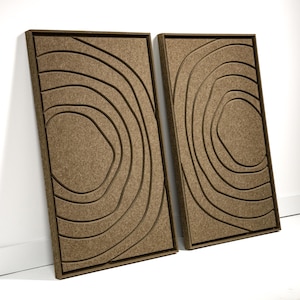 May include: Two rectangular, brown wall panels with a layered, topographic design. Each panel features concentric, curved lines within a dark brown frame. The panels are leaning against a white wall, showcasing a modern, abstract aesthetic.