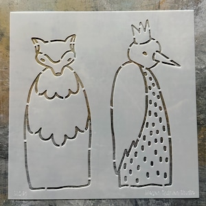 May include: A square, semi-transparent stencil sheet featuring two die-cut animal figures. On the left is a fox with a ruffled chest, and on the right is a bird wearing a crown with a spotted body. The text Megan Quinlan Studio is visible.