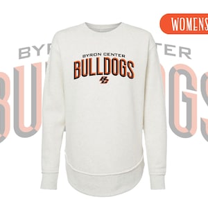 May include: A heathered light gray long-sleeve sweatshirt with a rounded hem. The chest features the text BYRON CENTER BULLDOGS in black and orange lettering, with the initials BC below. The background displays the word BULLDOGS in large letters.