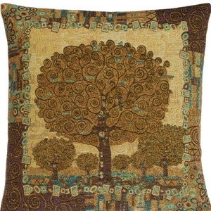May include: A decorative throw pillow with a tapestry design featuring a stylized tree with brown, gold, and green swirls. The pillow has a brown, gold, and green border.