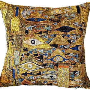 May include: A decorative cushion with a gold and blue tapestry design featuring stylised eyes and geometric shapes. The cushion is made of a soft, plush fabric and is perfect for adding a touch of art and style to any room.