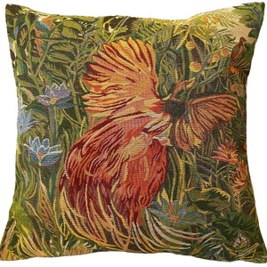 May include: A decorative throw pillow with a tapestry design featuring a colorful bird with its wings spread wide in a lush green jungle setting.