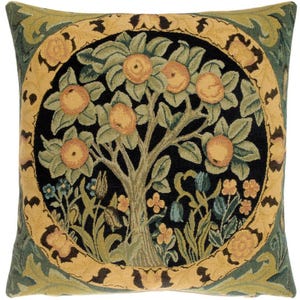 May include: A square throw pillow with a tapestry design featuring a stylized tree with green leaves and orange fruit. The tree is surrounded by a circular border with a floral pattern in shades of green, yellow, and brown. The background is black.
