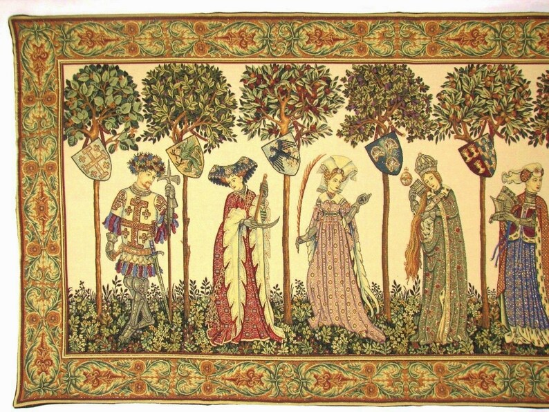 May include: A tapestry depicting a medieval scene with six figures standing in a garden setting. The figures are dressed in elaborate clothing and are holding various objects, including swords, shields, and a book. The tapestry is framed with a decorative border.