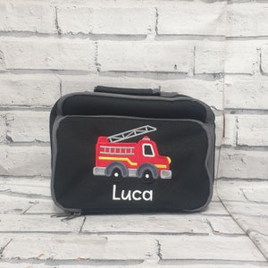 May include: Black lunch bag with a red fire engine and the name Luca embroidered on the front.
