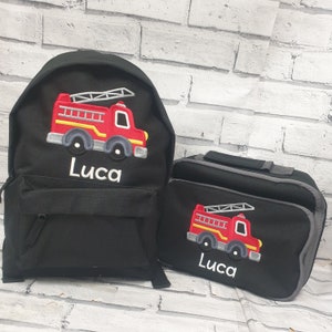 May include: Black personalized backpack and lunch bag set with a red fire truck design and the name Luca embroidered on both.