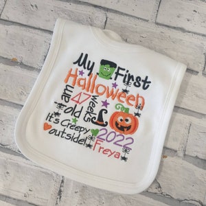 May include: White baby bib with embroidered text that says "My First Halloween I am 47 weeks old It's Creepy outside! 2022 Freya" with a pumpkin, witch hat, and monster graphic.