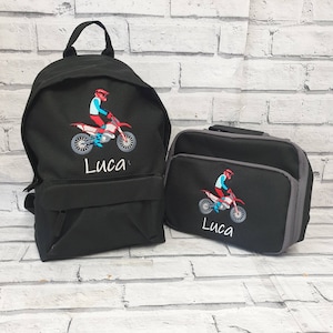 May include: Black backpack and lunch bag set with embroidered motocross rider and the name Luca.
