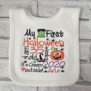 May include: White baby bib with embroidered text that reads "My First Halloween I am 35 weeks old It's Creepy outside! 2020 Arlo" with a pumpkin, witch hat, spider, and monster graphic.
