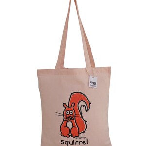 May include: A pink canvas tote bag with a red squirrel illustration and the text "digg design" and "squirrel" printed on it.