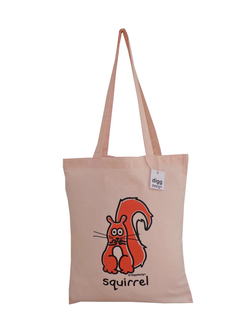 May include: A pink canvas tote bag with a red squirrel illustration and the text "digg design" and "squirrel" printed on it.