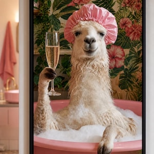 May include: A framed wall art print featuring a white llama wearing a pink shower cap, sitting in a pink bathtub filled with white soap bubbles. The llama holds a tall, clear glass filled with a golden sparkling beverage against a floral background.