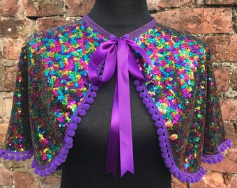 Rainbow Sequin Festival Cape with Choice of Colour of Pom Pom Trim and Ribbon Tie.