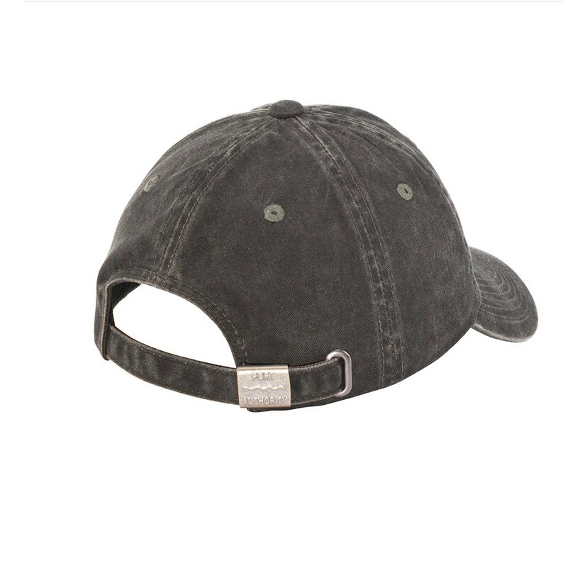 May include: A dark gray cotton baseball cap with a metal buckle closure. The buckle has the words "Puma Authority" embossed on it.