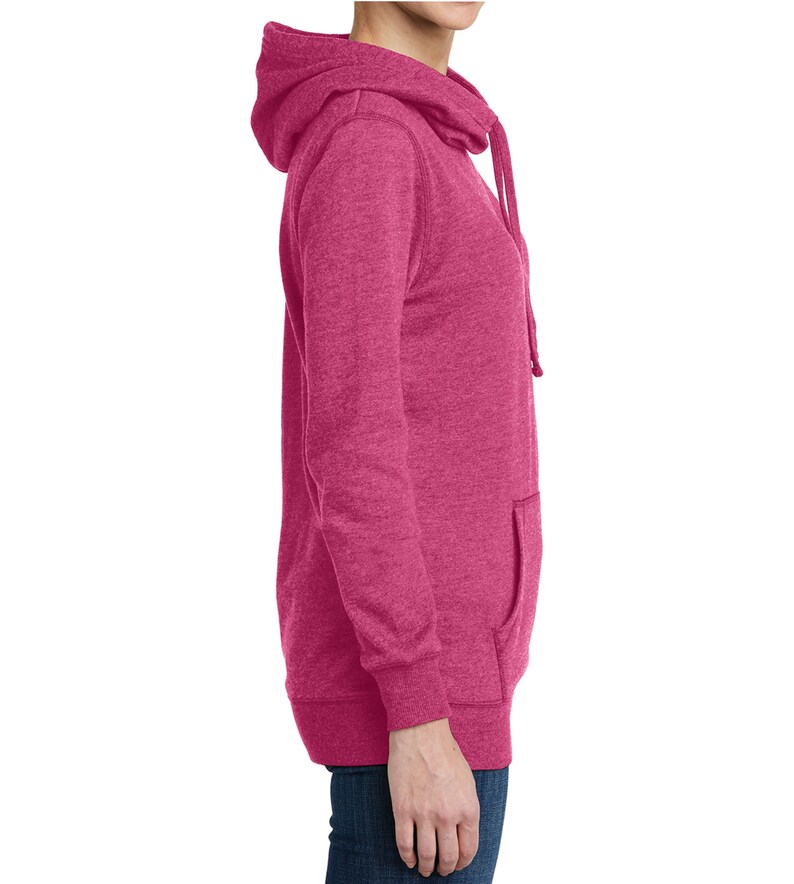 May include: A side view of a magenta hoodie with a drawstring hood and a kangaroo pocket. The long-sleeved sweatshirt is made of a soft, textured material. The hoodie is a solid color and has a relaxed fit.