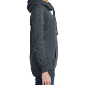 May include: A dark gray hooded sweatshirt with a long sleeve and a kangaroo pocket. The sweatshirt has a drawstring hood and a relaxed fit.