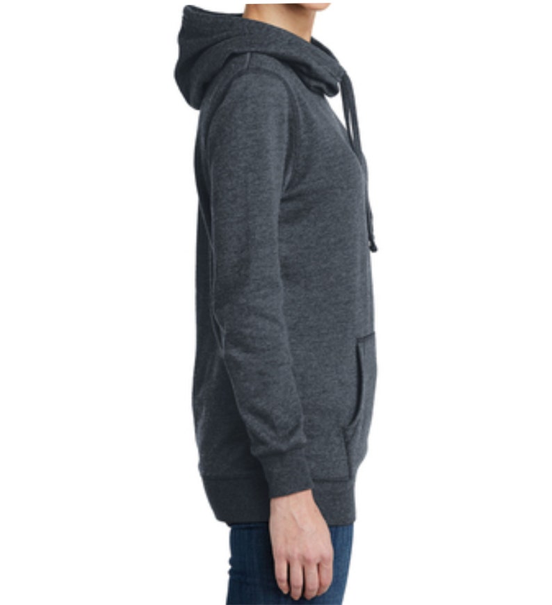 May include: A dark gray hooded sweatshirt with a long sleeve and a kangaroo pocket. The sweatshirt has a drawstring hood and a relaxed fit.