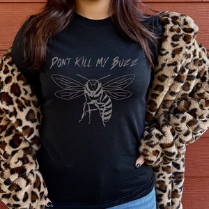 May include: Black t-shirt with a graphic of a bee and the text "Don't Kill My Buzz".