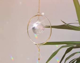 Saturn crystal suncatcher with stars and brass charms