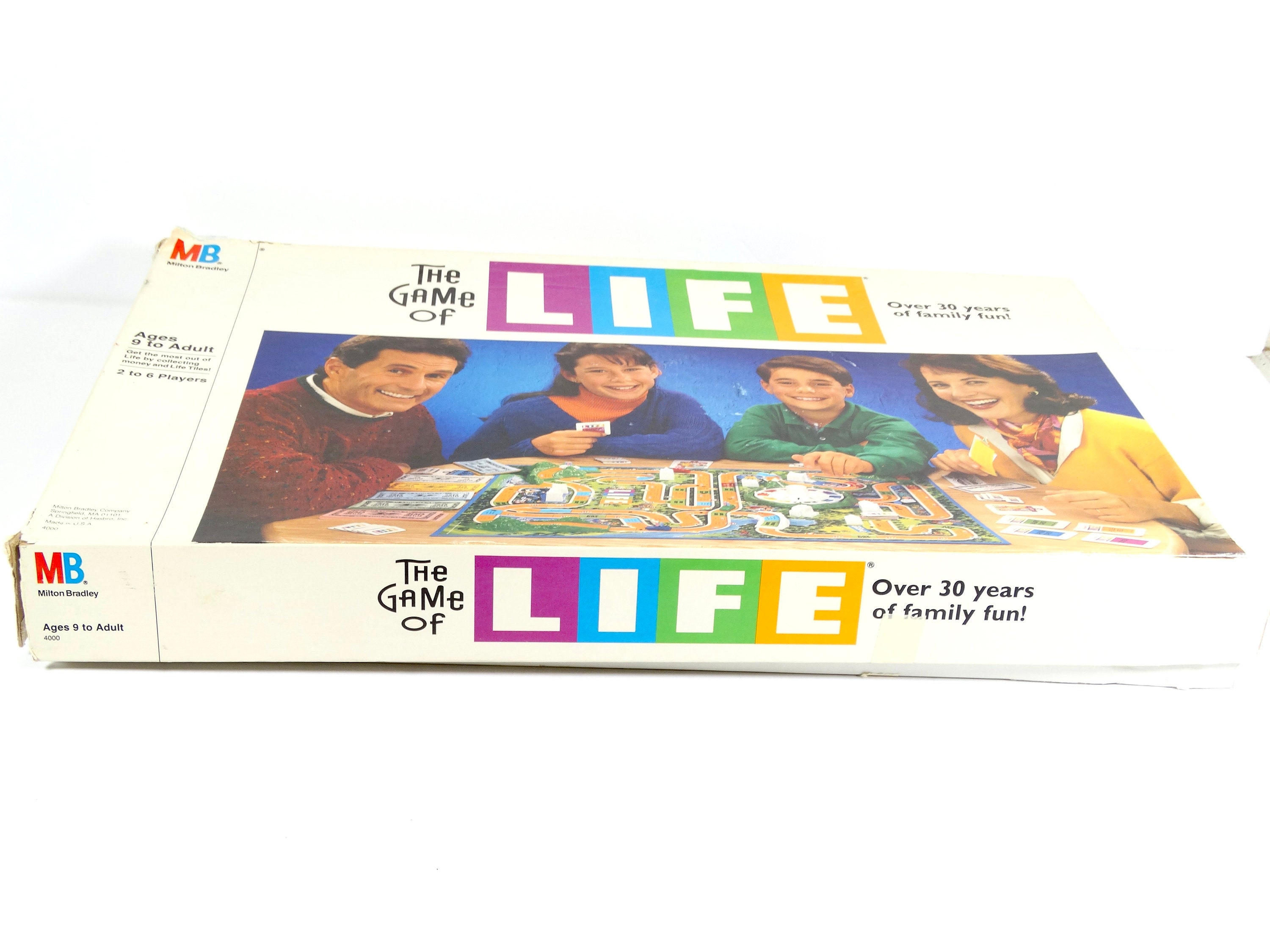 The Game of Life by Milton Bradley. The game board & all its