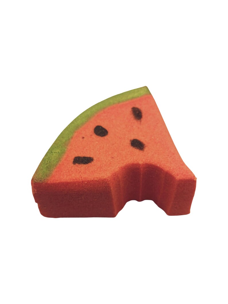 May include: A watermelon-shaped sponge with a bite taken out. The sponge is red with black seed details and a green rind. The image is isolated on a white background.