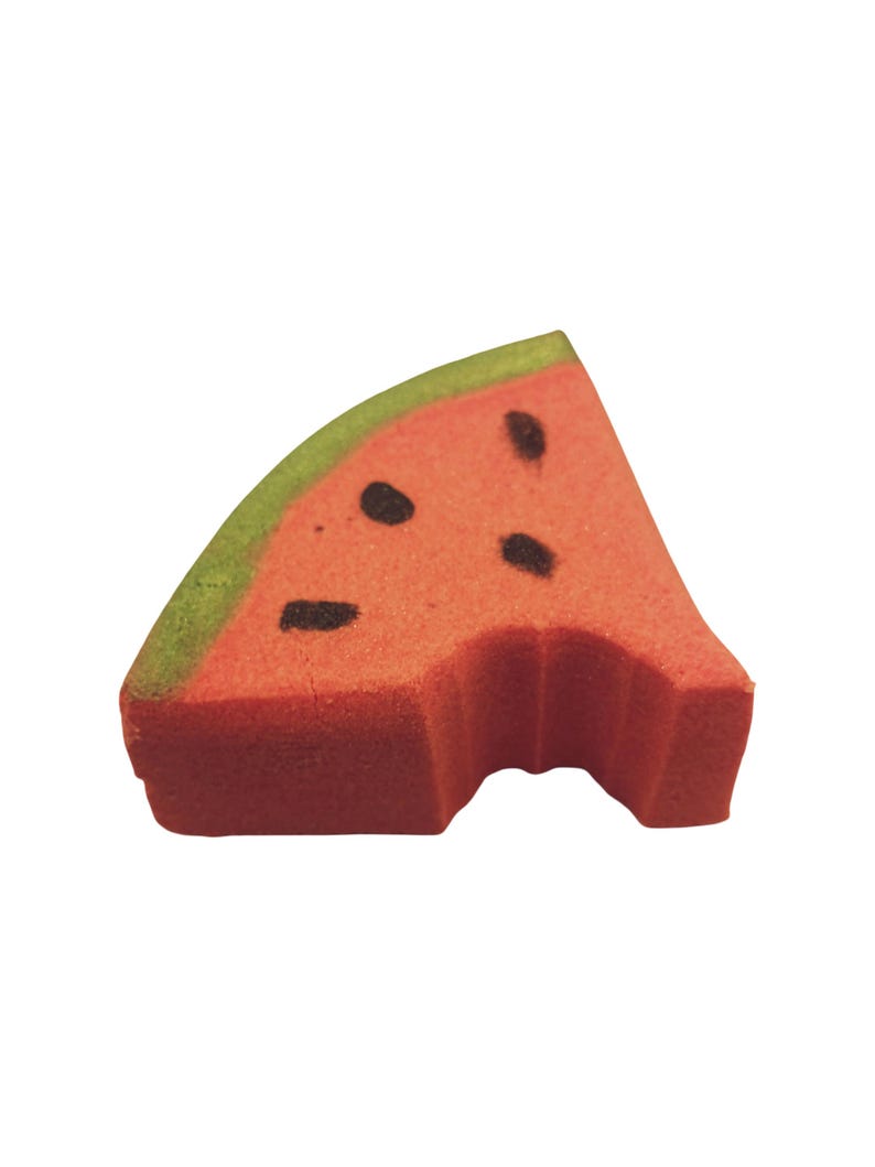 May include: A watermelon-shaped sponge with a bite taken out. The sponge is red with black seed details and a green rind. The image is isolated on a white background.