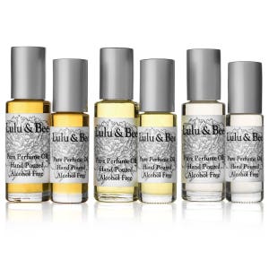 May include: Six glass bottles of alcohol-free perfume oil, labeled "Lulu & Bee Pure Perfume Oil Hand Poured Alcohol Free".