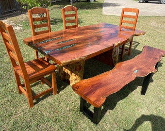 Mesquite dining table set with split trunk and connecting beam with chairs and bench.