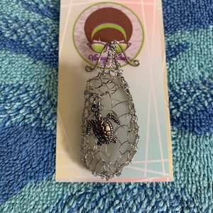 Handmade wire-wrapped glass pendant with turtle