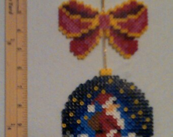 Perler Bead Christmas Orniment With Santa under a Starry Sky with Bow