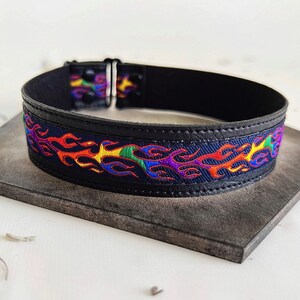 Rainbow flame print jacquard ribbon upper sewn onto a one inch wide black faux vegan leather choker collar base. Piece is adjustable and closes in back with a black metal hook. Tags lgbtq pride month queer gay goth flamer ribbon necklace punk rock