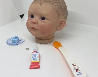 Poner un imán en la boca de un bebé Reborn para colocarle un chupete magnético, pdf corto y muy fácil