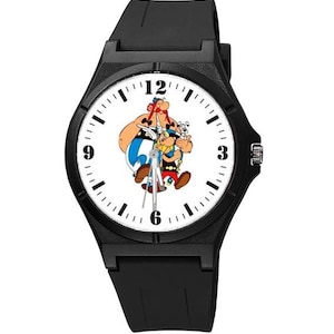 Può includere: Orologio da polso nero con quadrante bianco che presenta un'immagine a fumetti di Asterix e Obelix. L'orologio ha lancette nere e numeri neri.