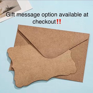 May include: A brown kraft paper envelope with a matching die-cut tag on a light blue surface. The tag has a decorative edge. Text in the image reads: "Gift message option available at checkout!!"