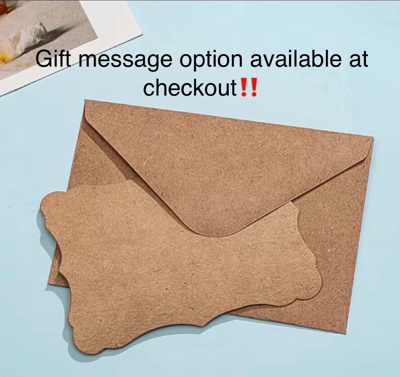 May include: A brown kraft paper envelope with a matching die-cut tag on a light blue surface. The tag has a decorative edge. Text in the image reads: "Gift message option available at checkout!!"